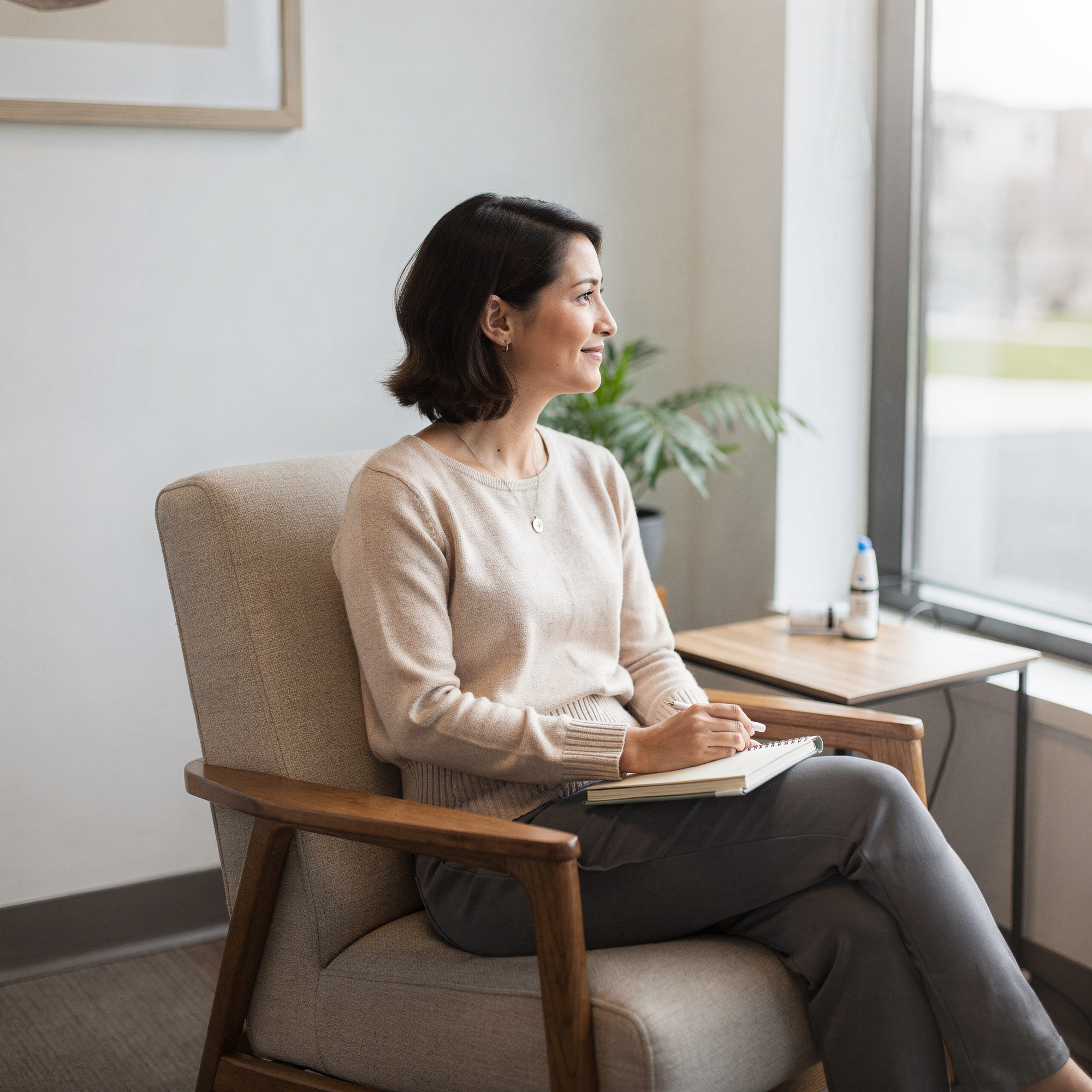 Patient sitting in a comfortable chair during a Spravato treatment consultation at a wellness clinic